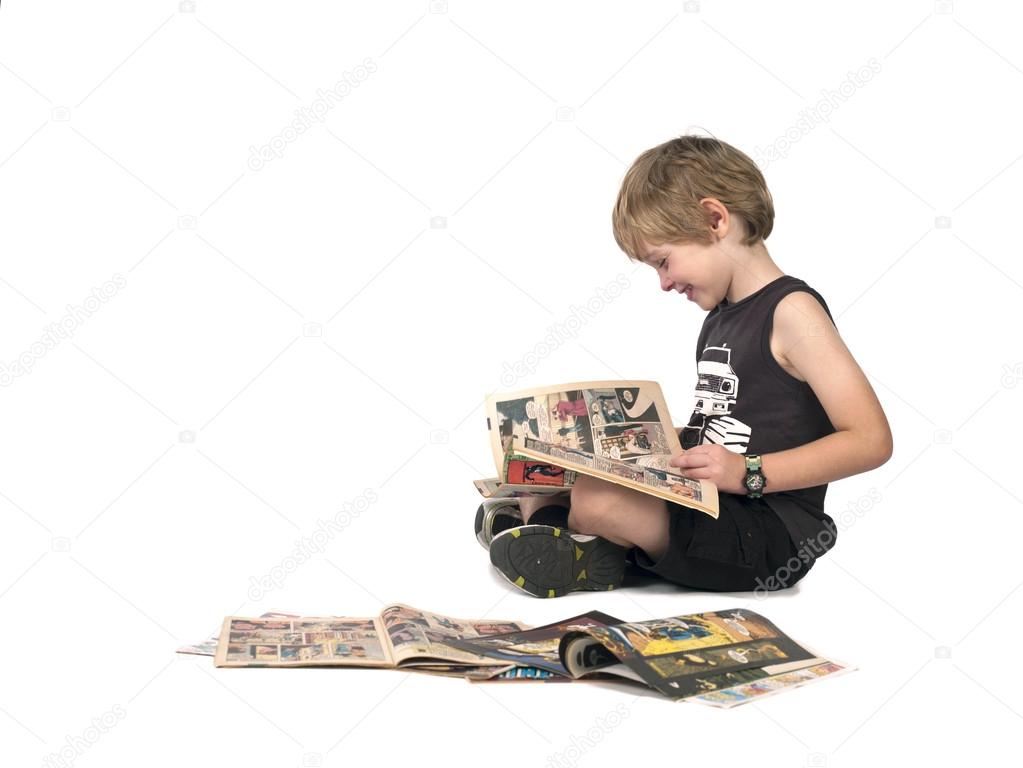 side view of a boy reading comic book