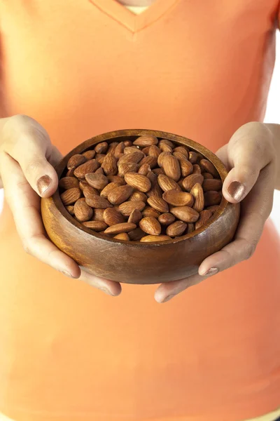 Woman holding bowl of almonds — Stock Photo, Image