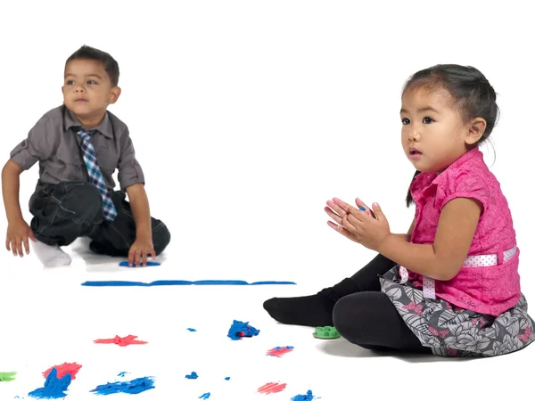 Curious boy and girl playing with color and clay — Stock Photo, Image