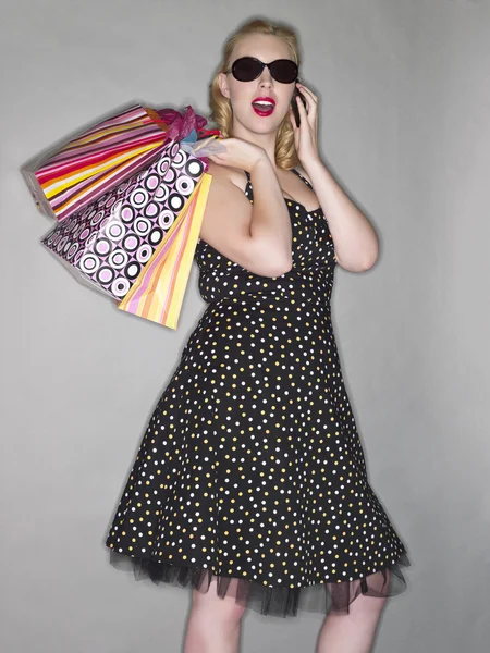 A lady shopper with shades and phone — Stock Photo, Image