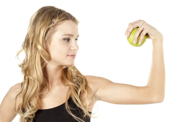 Señora flexionando su brazo con una manzana verde —  Fotos de Stock