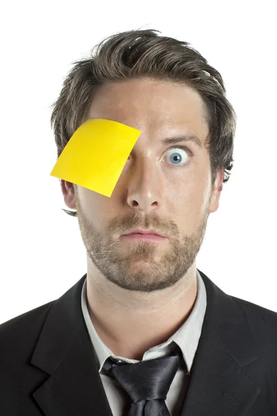 Businessman with sticky note in his one eye — Stock Photo, Image