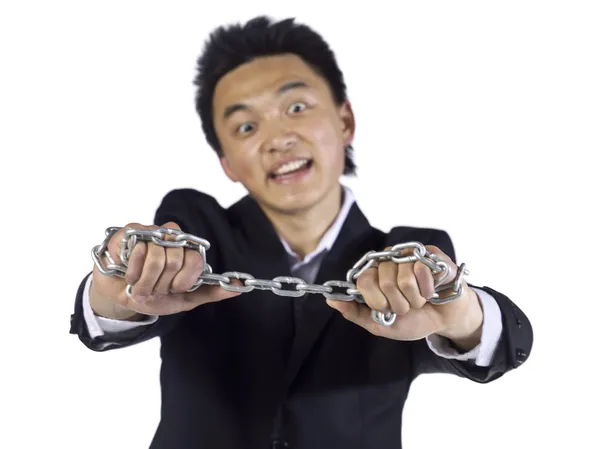 Asian teenage guy holding metal chain — Stock Photo, Image