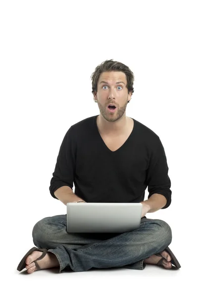 Good looking guy shocked while using laptop — Stock Photo, Image