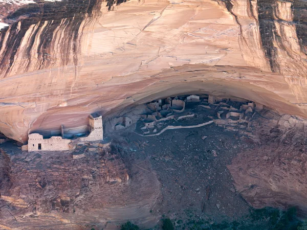 Дом из песчаника под скалой — стоковое фото