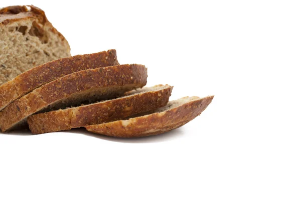 Loaf and slices of whole wheat bread — Stock Photo, Image