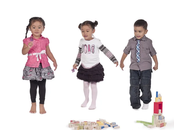 Asian kids with toys on white background — Stock Photo, Image