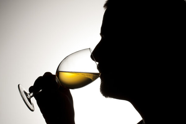 silhouette of a man drinking wine