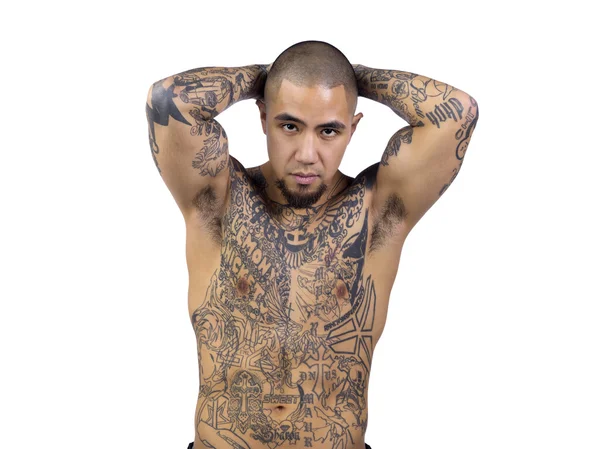 Attractive young man with tattoos posing with hands behind head — Stock Photo, Image