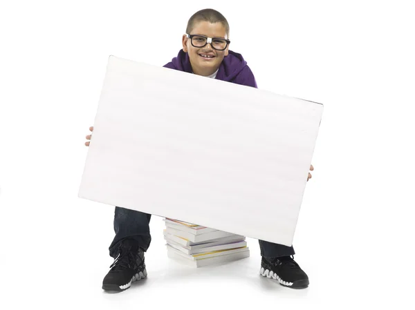 Boy sitting on books — Stock Photo, Image