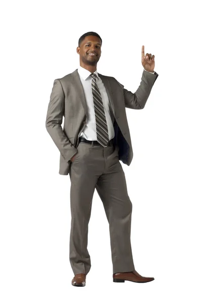 Schwarzer Geschäftsmann im Anzug zeigt mit dem Finger auf die Spitze — Stockfoto