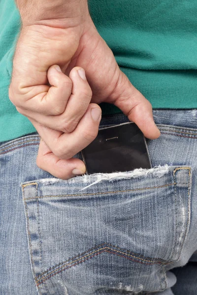 Cell phone on the back pocket — Stock Photo, Image