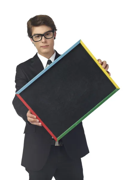 Handsome teenage guy with black empty board — Stock Photo, Image