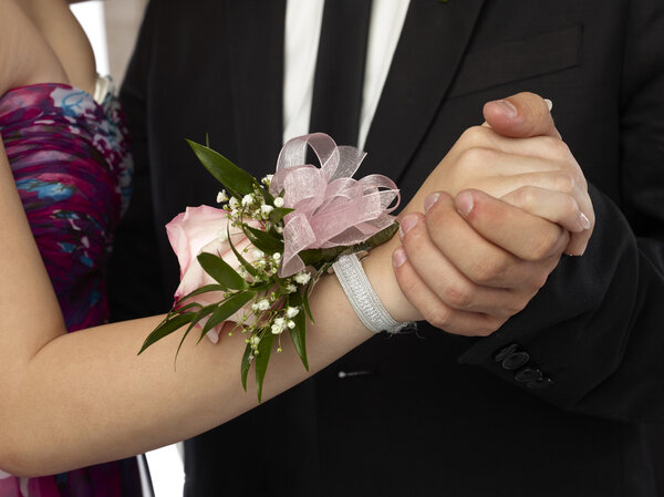 pink corsage in a woman wrist