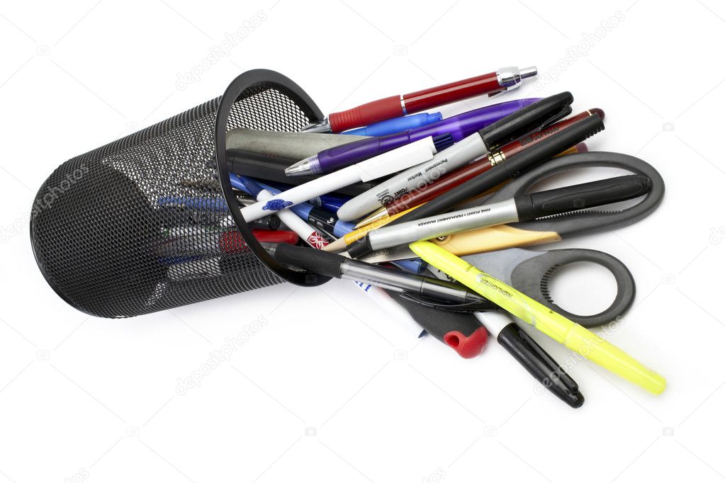 pens and scissors spilled on white background