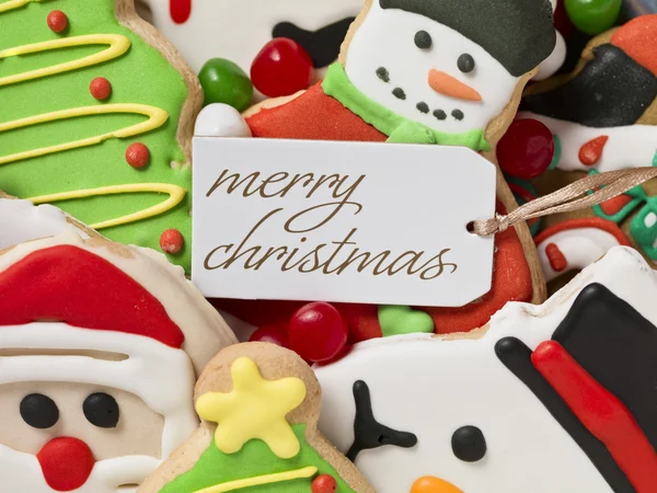 Christmas greeting tag and christmas cookies — Stock Photo, Image