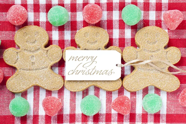 Close up image of gingerbread candies with merry christmas tag — Stock Photo, Image