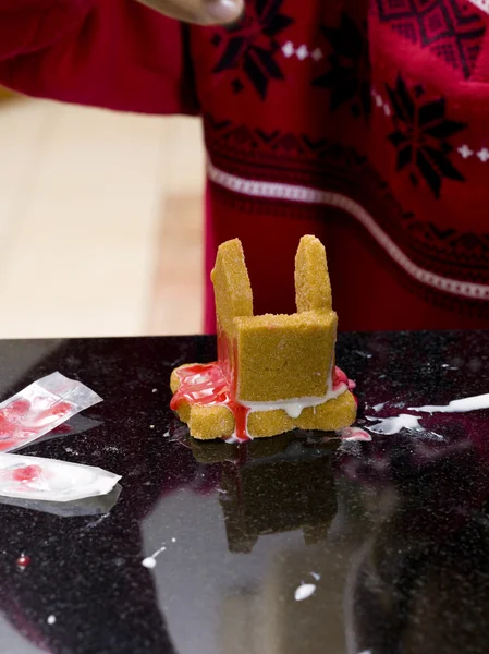 Close up of a boy working on gingerbread house — Stock Photo, Image