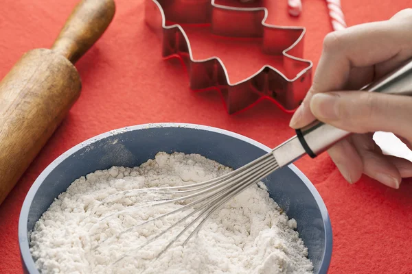 Close up shot of a person mixing flour in a bowl — Stock Photo, Image