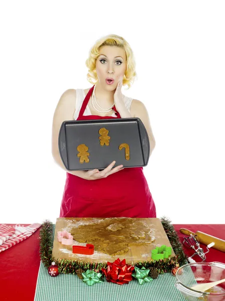 Surprised woman showing raw gingerbread cookies — Stock Photo, Image