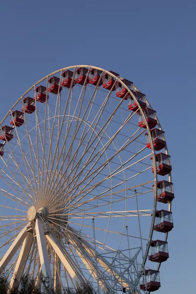 Low angle view of ferris wheel against blue sky Stock Picture