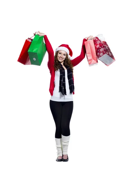 Happy young woman with arms raised holding shopping bags — Stock Photo, Image