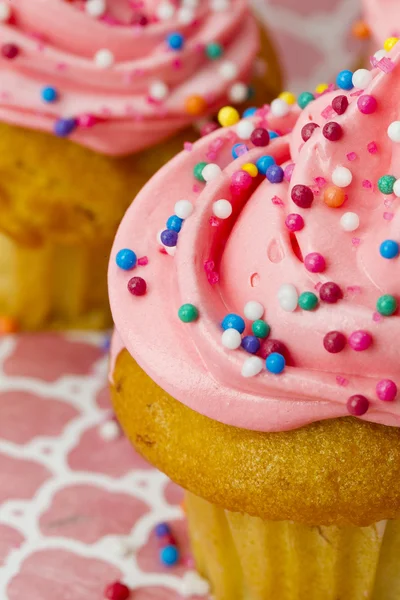 Close up cropped image of a strawberry cupcake with colorful sug — Stock Photo, Image