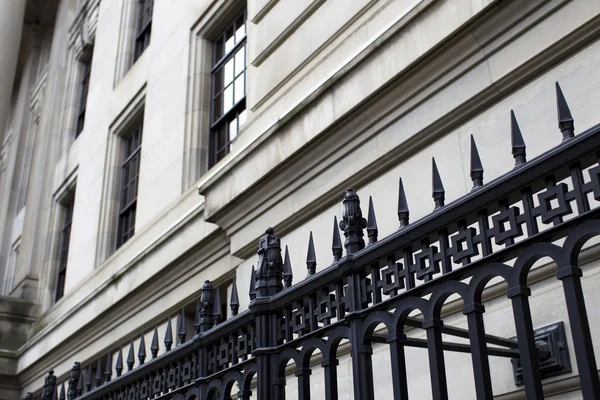 Low angle view of wrought iron with building in background — Stock Photo, Image