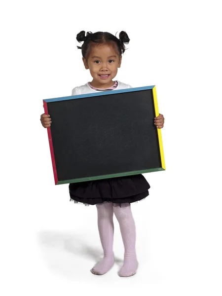 Smiling little asian girl holding slate board — Stock Photo, Image