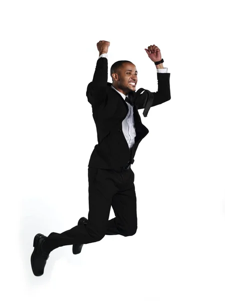 Side view of a excited businessman jumping in air — Stock Photo, Image