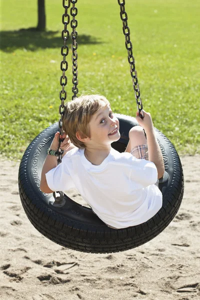 271 visão traseira de um menino balançando no balanço do pneu — Fotografia de Stock