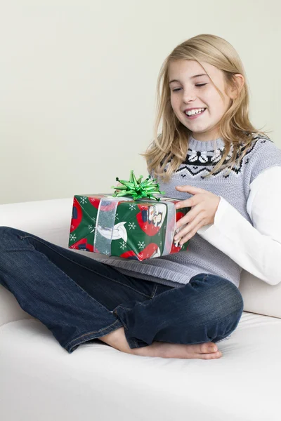 Sonriente chica sosteniendo su regalo de Navidad — Foto de Stock