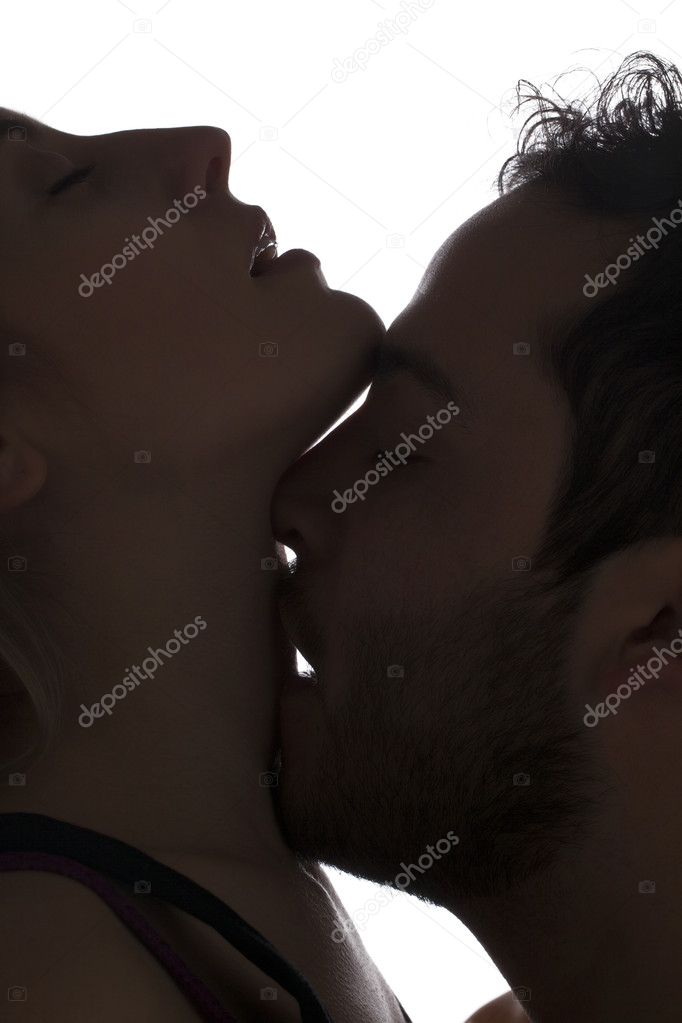 man kissing womans neck