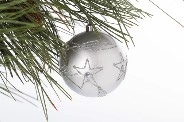 484 star shape on christmas bauble hanging on christmas tree — Stock Photo, Image