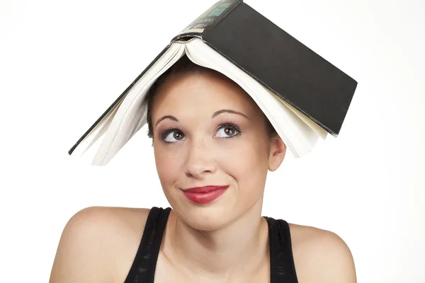 77 confused expression head shot with book on head — Stock Photo, Image