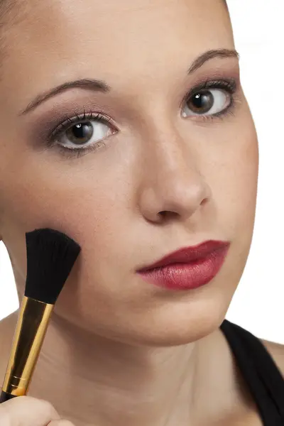 Teen model head shot brushes on makeup — Stock Photo, Image