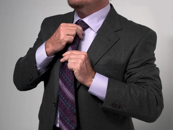 980 cropped image of a businessman adjusting necktie — Stock Photo, Image