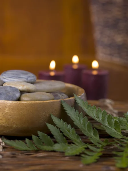 A bowl with spa stones and lighted candle — Stock Photo, Image