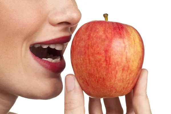 109 women biting into fresh apple closeup on white background — Stock Photo, Image