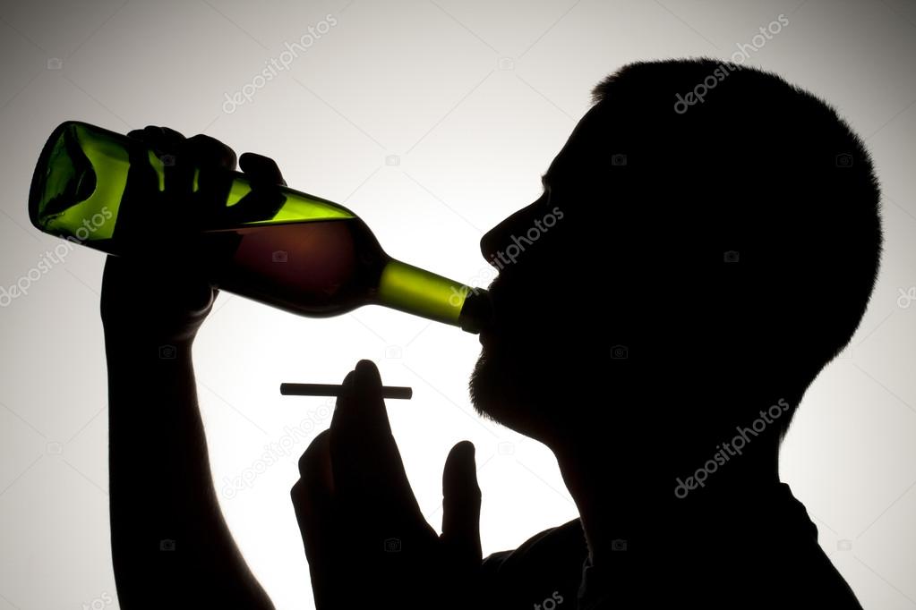 silhouette of man drinking wine with cigarette