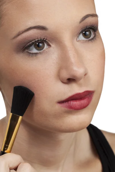 Teen model head shot brushes on makeup — Stock Photo, Image