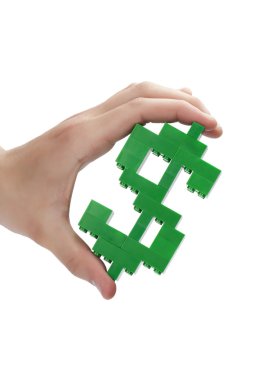 bir el üzerinde lego-den yapılmış bir dolar işareti tutarak