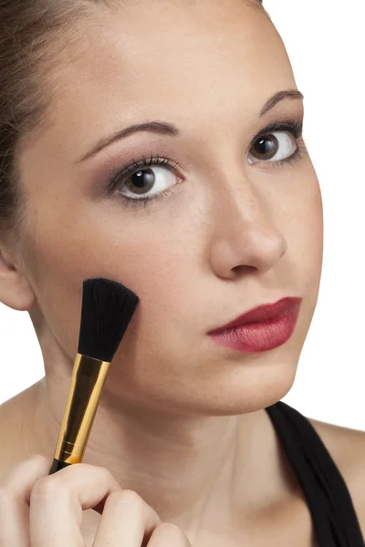 Teen model head shot brushes on makeup — Stock Photo, Image