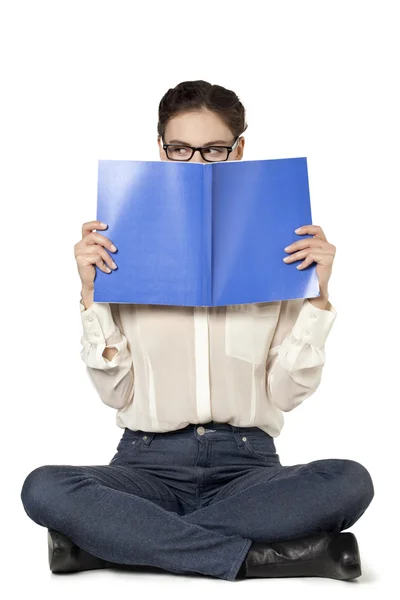 A female student holding a book and covering her face — Stock Photo, Image