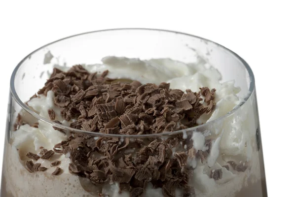 A glass of chocolate milk drink with cream and chocolate bits — Stock Photo, Image