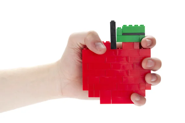 Een hand met apple gemaakt van lego blokken — Stockfoto