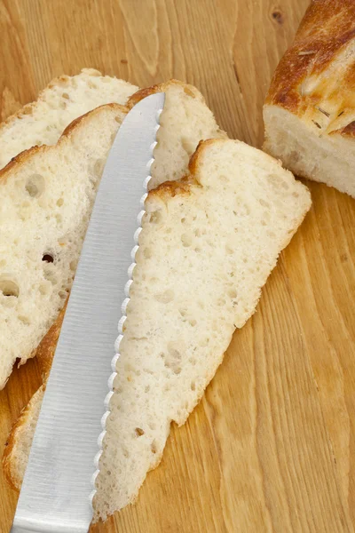 Uma faca cortando o pão — Fotografia de Stock