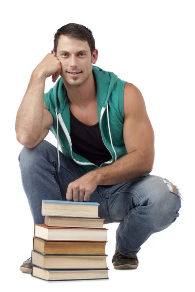 Un homme souriant avec des livres — Photo