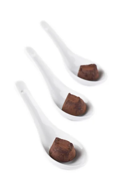 A soup spoon with chocolate truffles — Stock Photo, Image