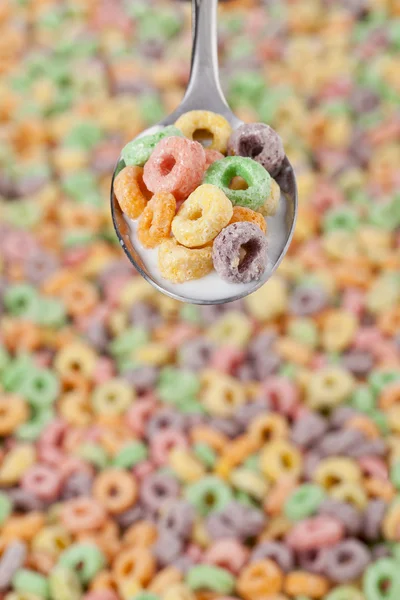 a spoon with colorful cereals